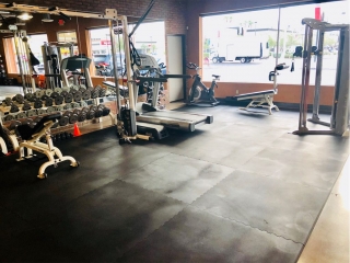 photo 3 of FIIT by Jason Smith facility showing cable crossover machine, treadmill, dumbbell racks, spin bike, TRX band, incline adjustable bench, Hoist Fitness machine and bar and attachment tree to maximize your weight loss