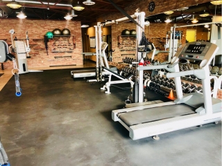 photo 2 of FIIT by Jason Smith facility showing dumbbell racks, treadmills, incline bench, resistance bands, resistance machine attachments and bars, functional training machine and cable crossover machine and more to maximize weight loss and muscle gain