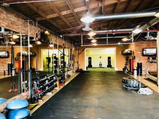 photo 1 of FIIT by Jason Smith facility showing bosu balls, dumbbell racks, medicine balls, resisitance bands, TRX bands, chin up bar, treadmill, punching bags, tire flip, battle ropes and more to help you meet your weight loss goal